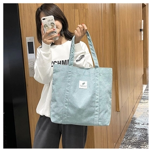 Large capacity mint green corduroy tote bag with vertical stripes and leaf label detail