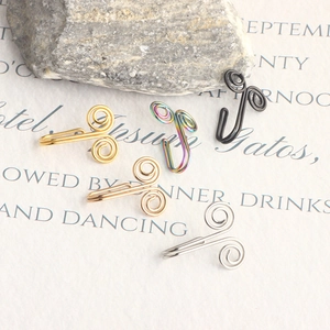Detailed set of five colorful spiral faux nose rings on artistic background paper