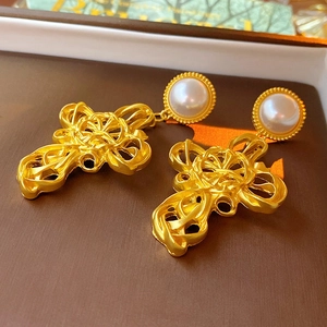 Vintage style gold cross earrings with pearl stud and intricate hollow texture