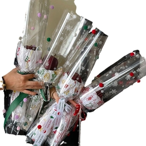 Christmas snowflake cellophane wrapping bags with festive pom-poms and Merry Christmas ribbon