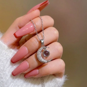Silver crescent moon necklace with red projection stone and micro-inlaid zircons