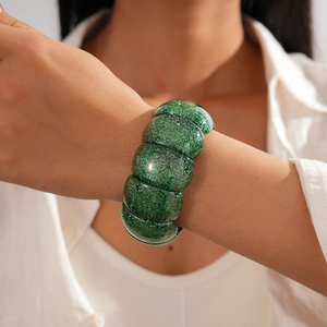 Detailaufnahme eines grünen Glitzer-Resin-Armbands mit quadratischem Blockmuster