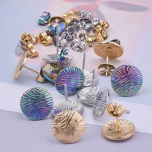 Macro shot of ripple textured stainless steel stud earrings in gold, silver, and rainbow color