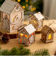 Detail of light-up wooden Christmas house ornaments with warm LED and rustic hemp rope