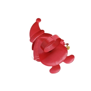 Red metal Santa Claus Christmas napkin ring with bell decoration on white background