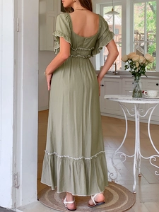 Détails de la robe longue verte avec dos nu à volants et liserés blancs contrastés