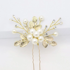 Elegant gold bridal hair pin with white pearls and sparkling rhinestones for wedding styling