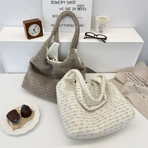 Detail of plush tote bags with metal snap button in a cozy French bakery setting