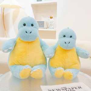 Detail of soft blue and yellow dinosaur plush toys on a stylish ribbed glass table
