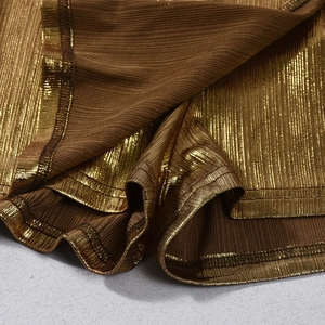 Close-up of metallic bronze pleated fabric with refined stitching and shimmering texture