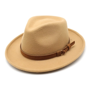 Close-up of camel wool fedora hat with brown leather band and gold buckle detail