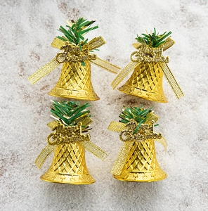 Detail showing four gold Christmas bells with bows and Merry Christmas tags on snow