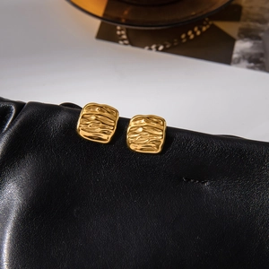 Classic 18K gold plated stainless steel square earrings with hammered texture on black leather