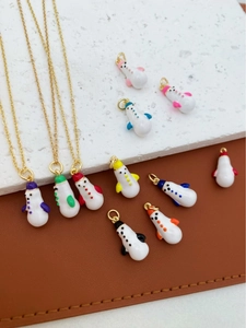 Detailed view of colorful snowman enamel pendants and necklaces for winter gift decoration