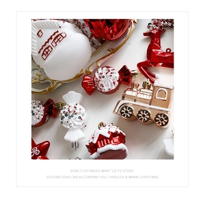 Flat lay of red and gold Christmas ornaments with Santa, candy, and star shapes