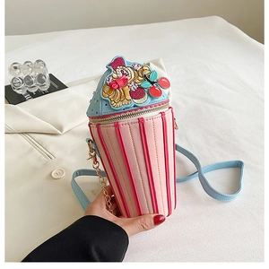 Detail shot of mini dessert cup crossbody bag with pink leather and golden chain strap