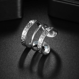 Irregular textured silver stainless steel wrap ring with a minimalist geometric design