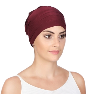 Detail of burgundy pleated chemo headscarf showing soft fabric texture and layered folds