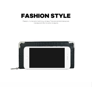 Detail of black crocodile pattern long clutch bag with silver metal corners and size comparison