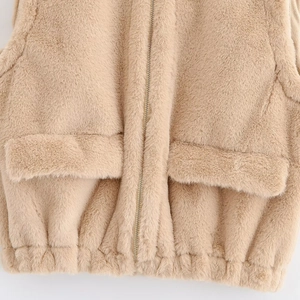 Sleeveless faux fur vest jacket with metal zipper, flap pockets and elastic hem in camel