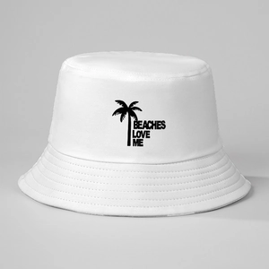 Close-up of white canvas bucket hat featuring black Beaches Love Me and palm tree print