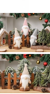 Close-up of knit Christmas gnomes with pentagram hats and wooden bases on a festive table