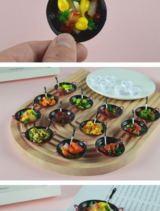 Miniature dollhouse food set showing detailed resin dishes in tiny black woks