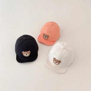 Detail of three soft-brim baby baseball caps featuring cute bear towel embroidery patches