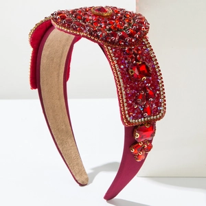 Detail of vintage red velvet headband with luxurious rubies and shiny rhinestones