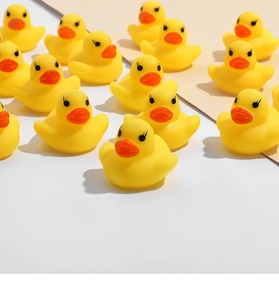 Close-up of cute yellow rubber ducks with orange beaks for baby bath time fun