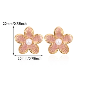 Detailed view of 20mm flower stud earrings with pink enamel and pearl center in gold