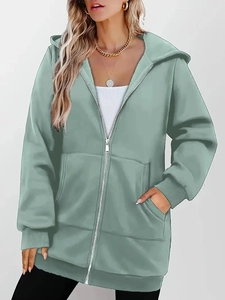 Detail of pea green zip-up hoodie featuring hooded design, dual pockets and ribbed cuffs