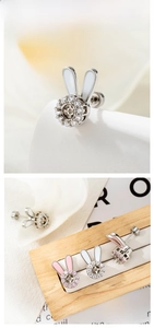 Detail of silver bunny ear studs with pink enamel and sparkling crystal inlay