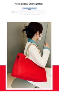 Model wearing large red canvas tote bag with thick rope handles for daily commute