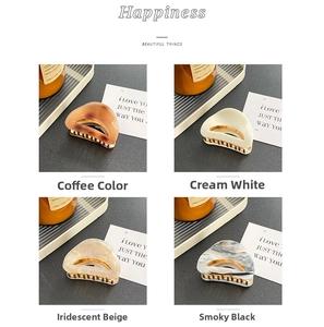 Detailed comparison of four hollow acetate hair claws in amber, cream, beige, and black