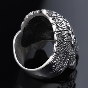 Vintage silver punk eagle feather ring with detailed metal textures on black background