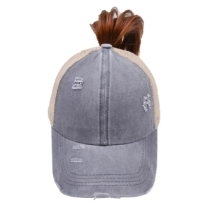 Detail of washed cotton ponytail baseball cap with mesh back and distressed hole accents