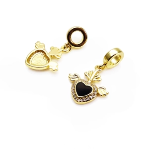 Detail of golden heart wing pendants with micro-set zircon and hollow design