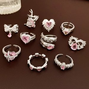 Detailed set of silver finish open rings featuring pink zircon stones and heart designs