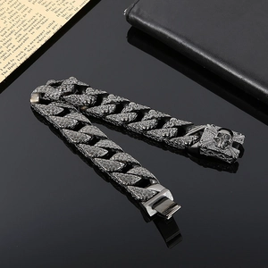 Detail of punk style skull carving on heavy metal Cuban chain bracelet for men