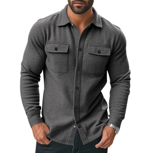 Detailed view of dark grey men's workwear jacket with chest pockets and brushed texture