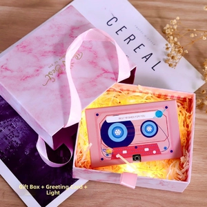 Pink marble gift box with retro cassette recording card and warm LED fairy lights