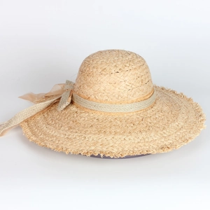Wide brim raffia straw sun hat with decorative ribbon bow for beach vacation