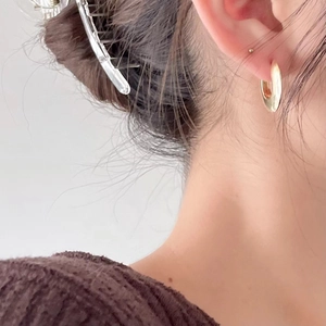 Minimalist gold hoop earrings for women with a sleek mirror finish and geometric design