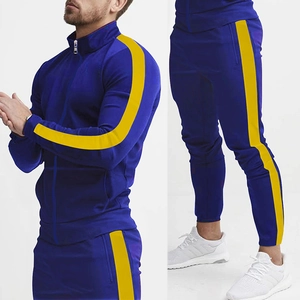 Detail of blue track suit with yellow side stripes featuring stand collar jacket and slim pants