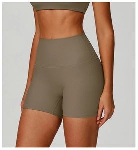 Close-up of ribbed texture and wide waistband on olive green high-waist yoga shorts