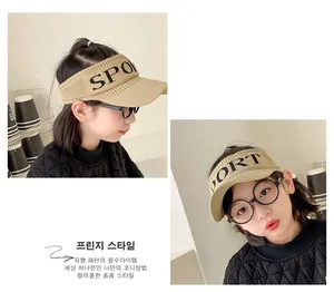 Detailed knit texture of beige sport sun visor with black SPORT letter embroidery