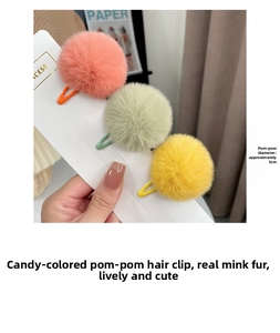Detail view of 5cm real rabbit fur ball hair clips in pink, green, and yellow colors