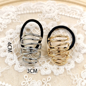 Detail view of gold and silver alloy ponytail cuffs with dimension markings 4x3cm