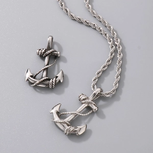 Macro detail of vintage silver anchor pendant with rope texture and twisted chain